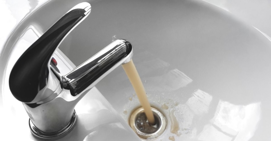 Discolored water running from the faucet.
